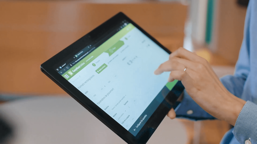 man holding ipad with software